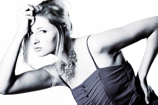 Young girl in a dress in the studio on a white background. 