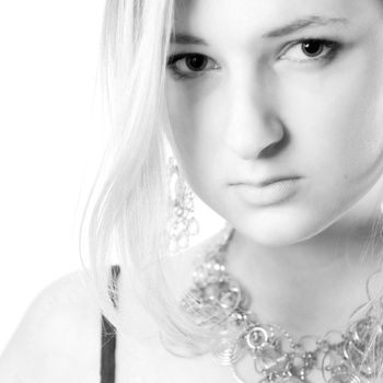 Young girl in a dress in the studio on a white background.