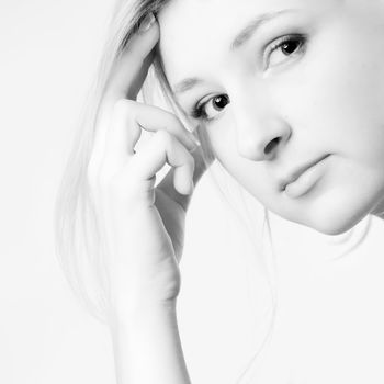 Young girl in a dress in the studio on a white background.