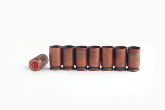 row of cartridge-cases on white  background