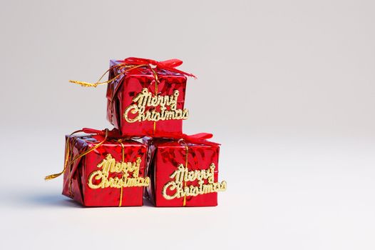 Red gifts on white background. Christmas decoration.