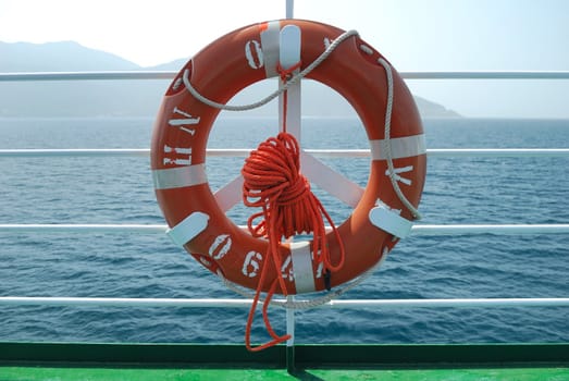 Red lifebelt on boat deck