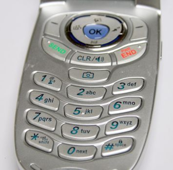 keypad of a new cell phone, in a silver case