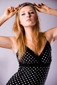 Beautiful girl with a pair off sunglasses in the studio