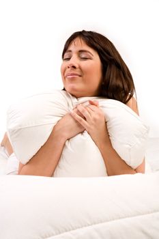 Cute girl in bed hugging her pillow