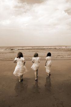 a picture of the time of the first communion and the joy thereafter of three friends going into the sea for a paddle