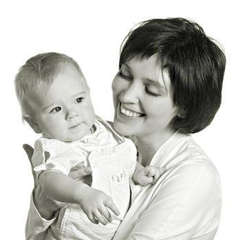 On hands at mother the little girl lasts aside and shows a finger on a white background
