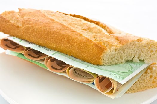 Fresh white loaf with a layer of monetary denominations inside

