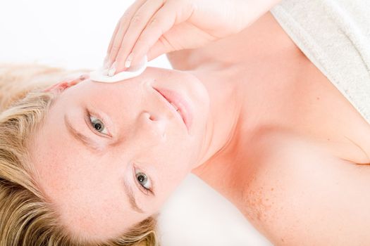 Studio portrait of a spa girl cleaning her face