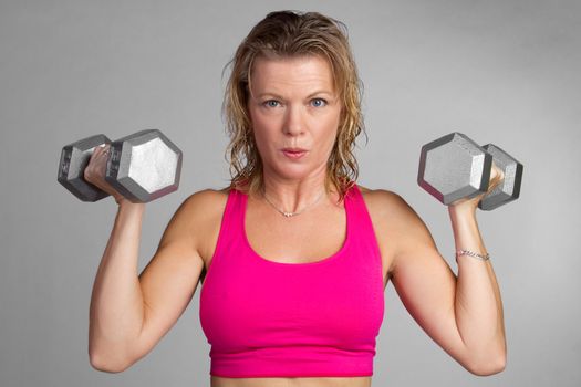 Middle aged fitness woman exercising