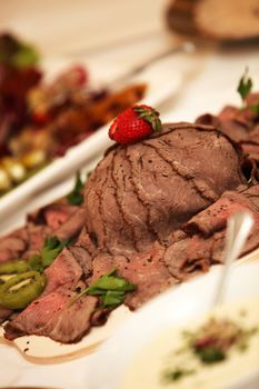 roast beef, served with delicious strawberry kiwi and decorated, close-up