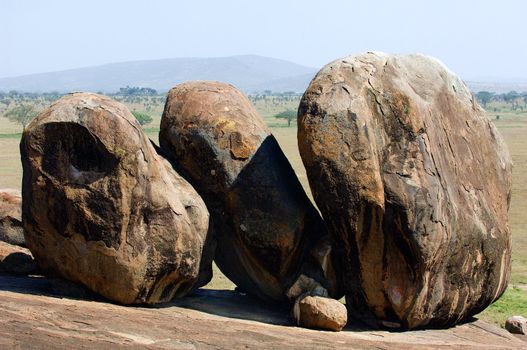 Big boulders lying on top of a large solid rock: Landscape 