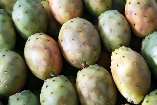 Ripe fresh pickly pears in crate on market