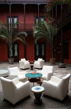 Cafe indoor with white sofas and blue glass small table