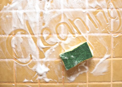 sponge have written "cleaning" on soap wall