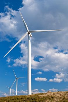 Beautiful meadow with Wind turbines generating electricity.