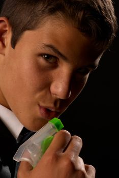 Teen impersonating 007 using a cleaning spray