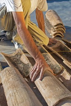 Construction worker interlocking spanish roof tiles