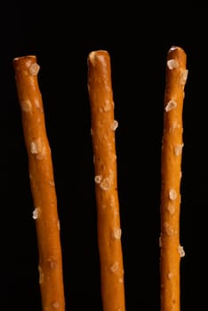 Crunchy salted sticks in vertical take, classic snack