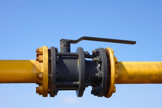 The gas valve on the background of clear blue sky. Blocking damper on gas pipe