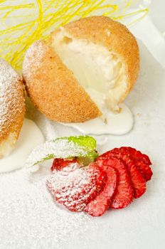 Dessert of ice-cream at biscuit with strawberry and caramel