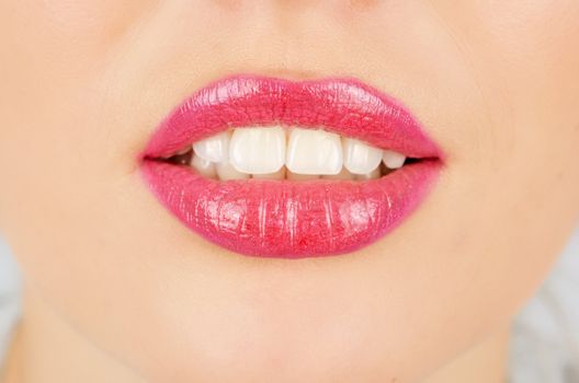 Close up of a young woman's glossy lips