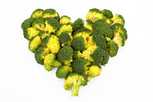 Small bunches of broccoli shaped like a heart. Isolated