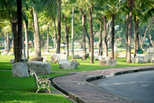 Empty bench in Lumphini park, Bangkok, Thailand