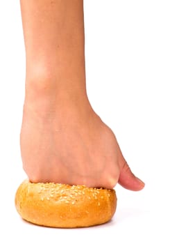 Fist pressing a fresh bun, isolated on the white background