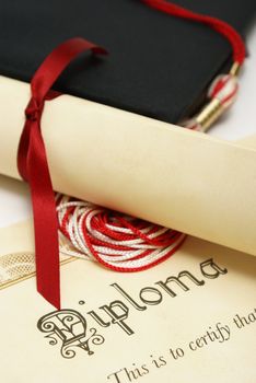 A diploma and grad hat represent a high achieving student.