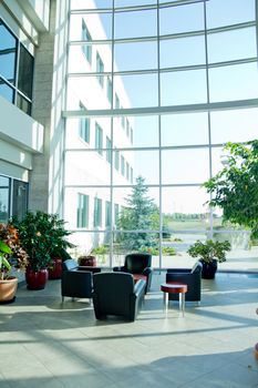 Sofa and table setup on a bright well lit room with a glass wall