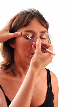 a woman working on a make up , focus on the eyes