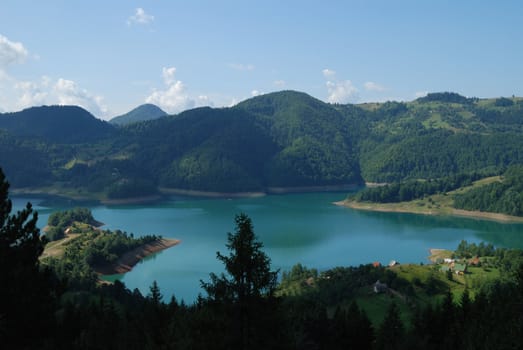 Beautiful village on the lake in mountain. Fisherman dream