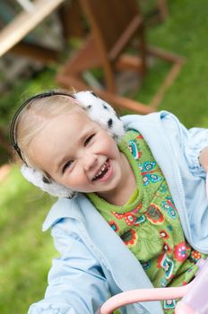 Shot of little girl in headphones playing outside