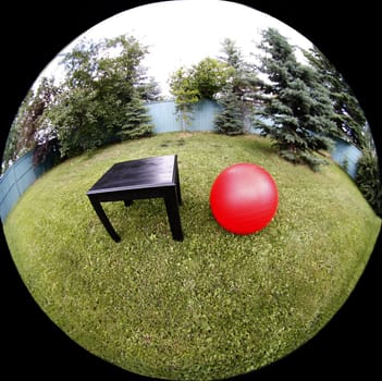 Grass, black ytable red ball
Abstract