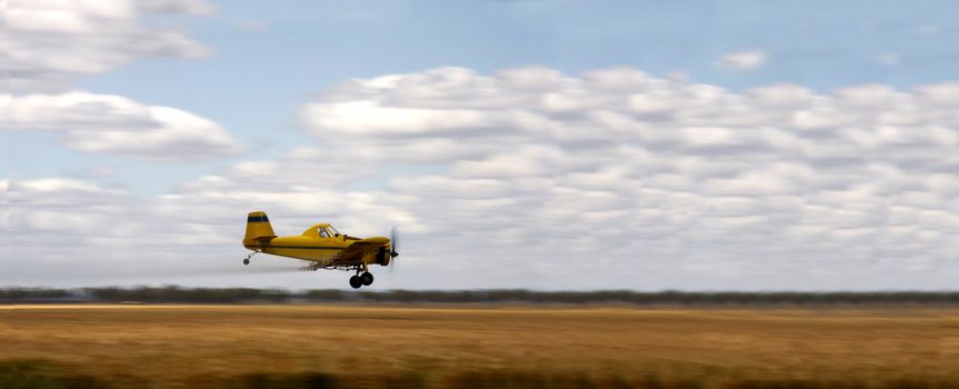 Small crop duster plane on the field