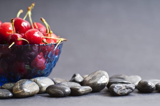 jar with cherries and gray background
