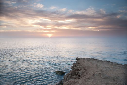 Sunrise and Dramatic sky over a clam ocean,