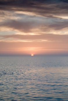 Sunrise and Dramatic sky over a clam ocean,