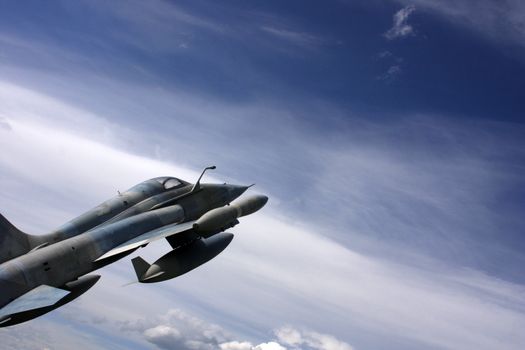 Fighter jet flying through the clouds