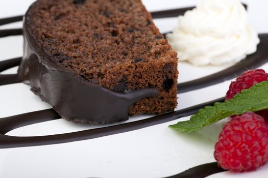 Fresh chocolate cake with raspberries and whipped cream.