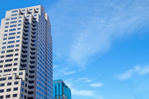 Two office buildings with blue sky cloudscape