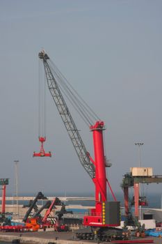 Red crane at a port