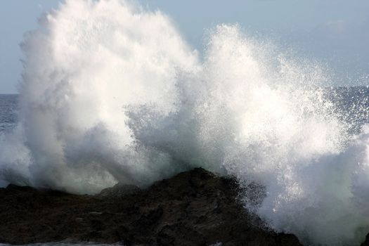 Big waves are breaking on the rock