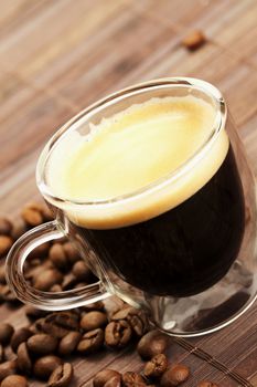 diagonal espresso with coffee beans on wooden background