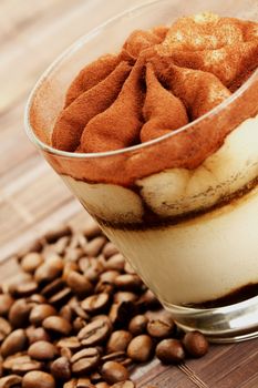 tiramisu diagonal with coffee beans on wooden background
