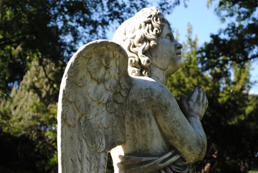 A praying angel statue.