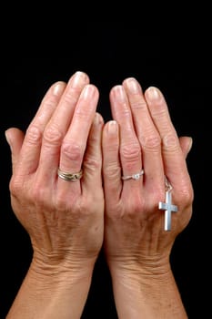 Woman is showin her hands. On clean black bagground.