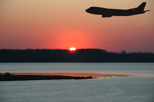 Sunset and a silhouette of plane.