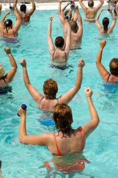 People doing aerobic in a swimming pool